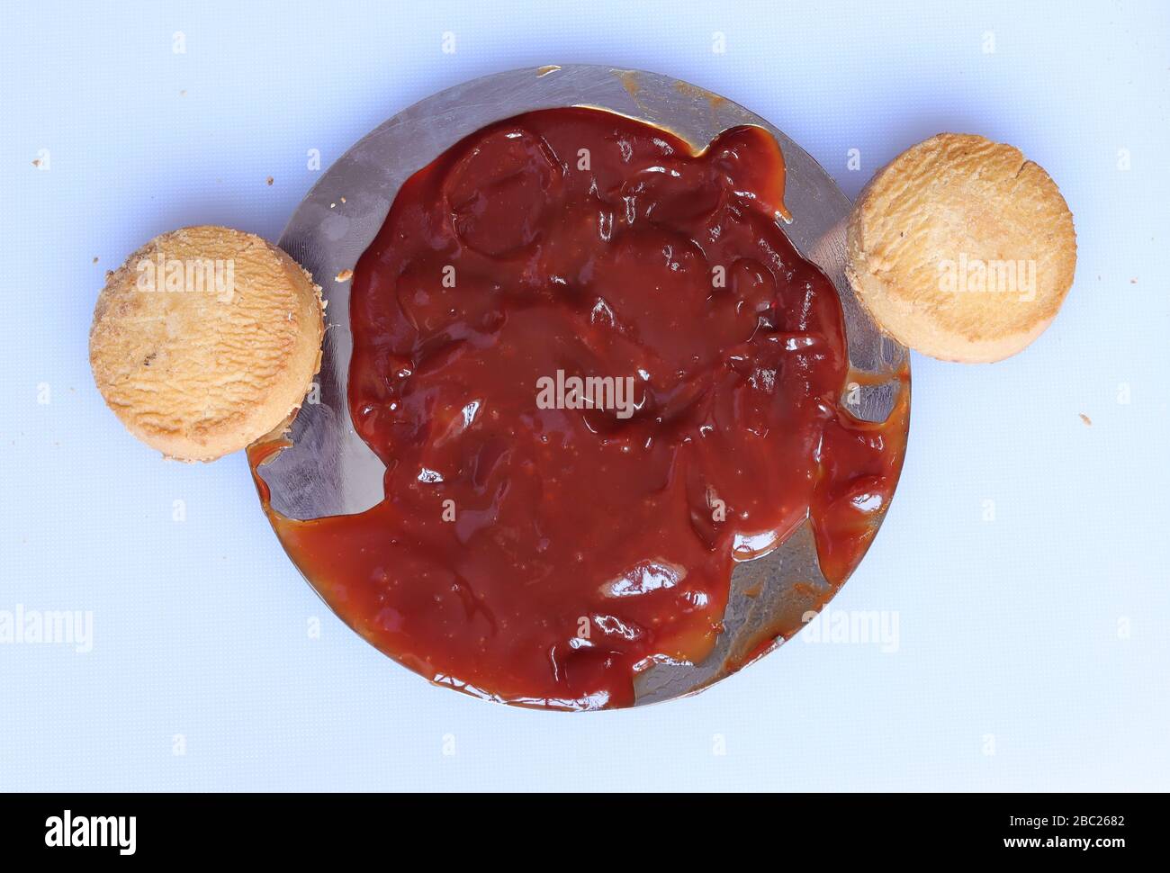 red ketchup splashes  with biscutis isolated on white background Stock Photo