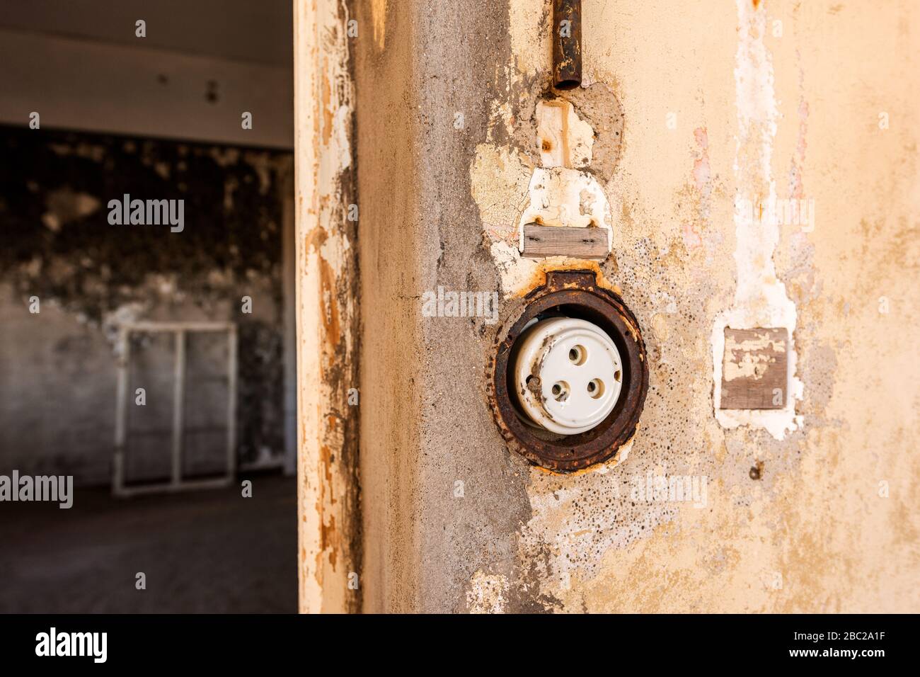 A close up photograph inside an abandoned house of an old electrical