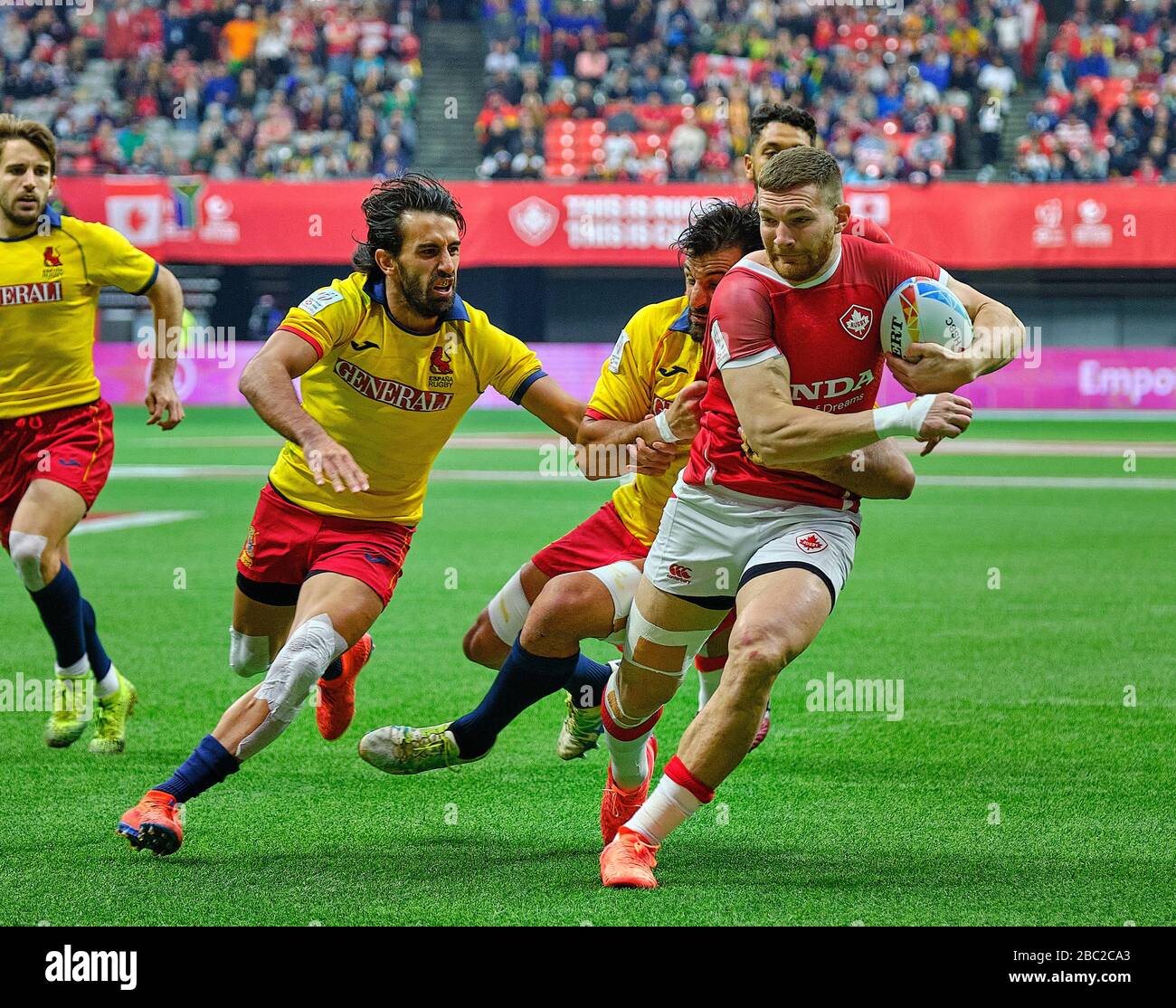 Vancouver, Canada. 8th March, 2020. Isaac Kaay #2 of Canada tackled by Spain players in Match #32 (Cup Quarter Finals) during Day 2 - 2020 HSBC World Stock Photo