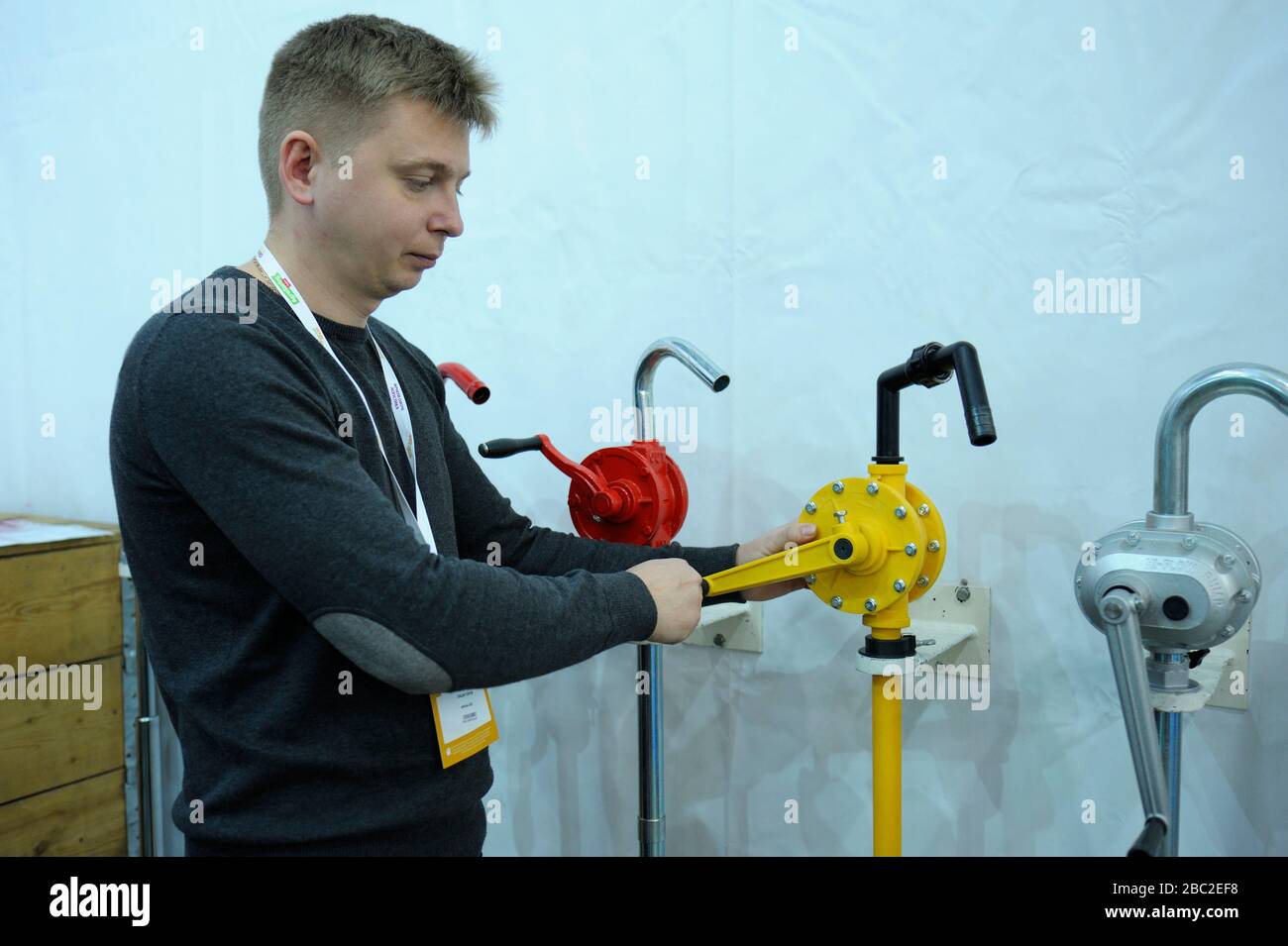 Sales manager shows Rotary hand pumps placed on stand Stock Photo