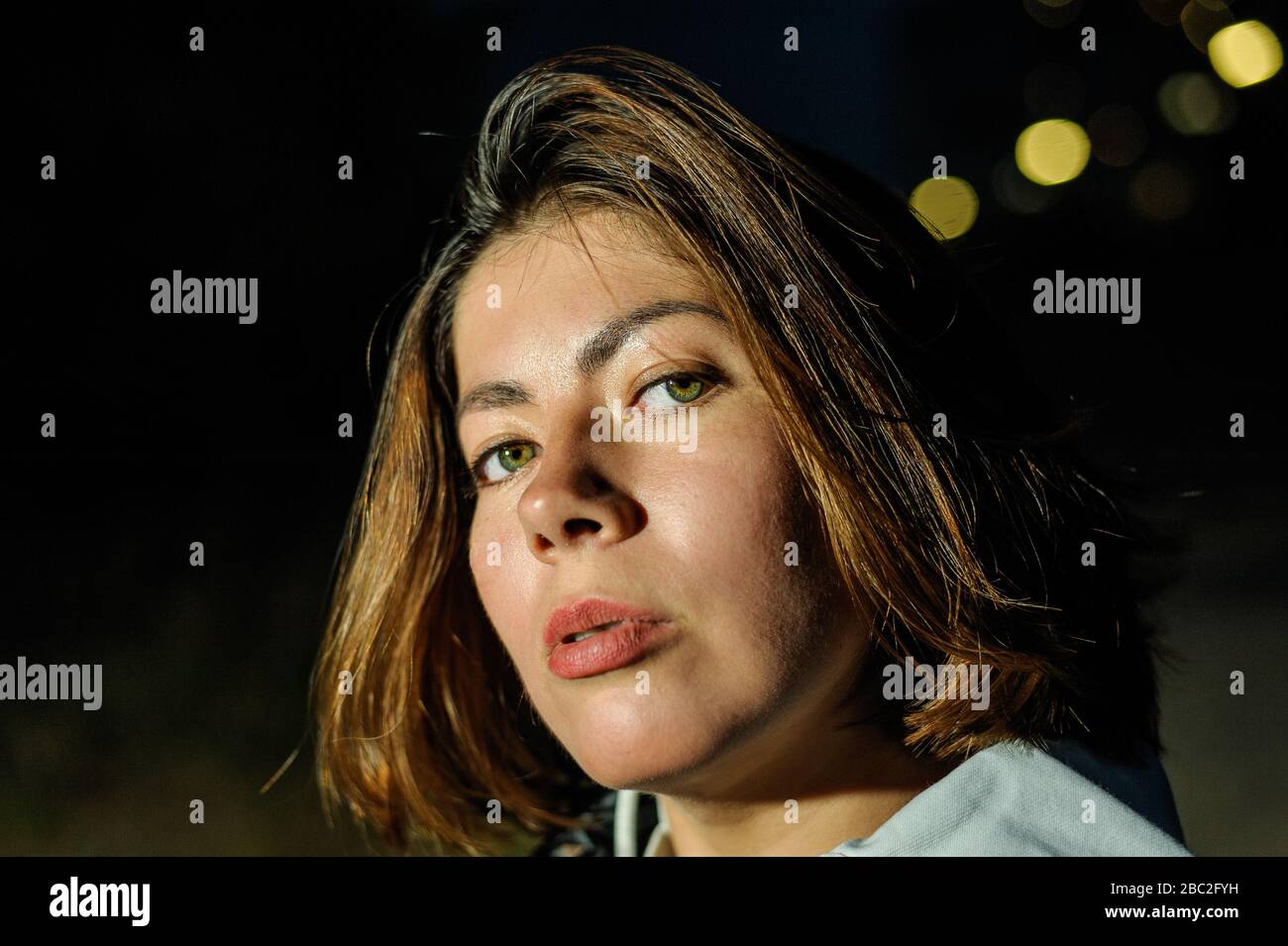 Close-up portrait of the face of a beautiful dark-haired young woman at dusk Stock Photo