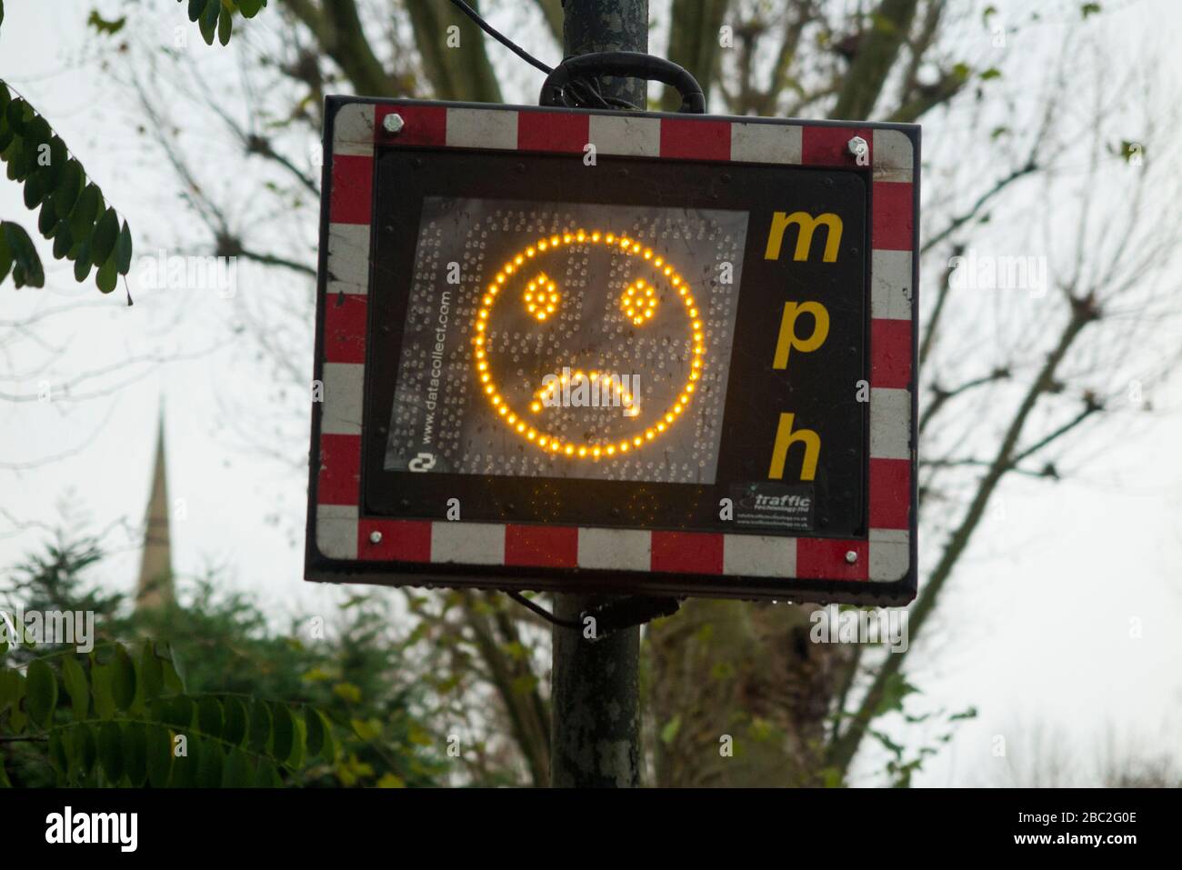 Speed Indicator Device (SID) in Hampton / Teddington, London, on a 20 mph mile per hour stretch of road: it displays a sad emoticon as a speeding car approaches or at excessive speed of approaching cars / vehicle. Stock Photo