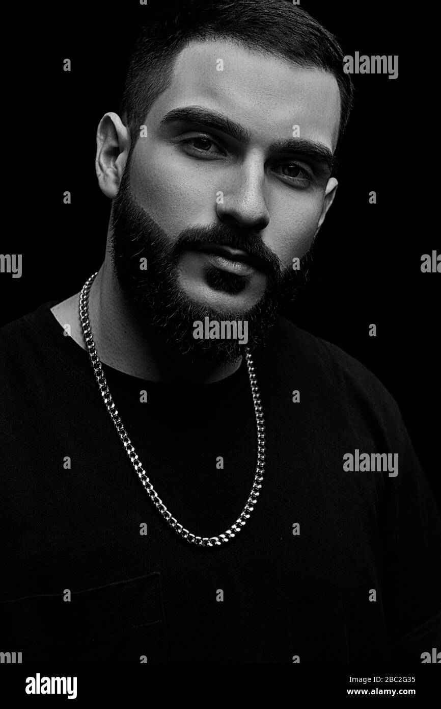 German Rapper With Beard close-up of a dramatic portrait of a young serious guy, musician ...