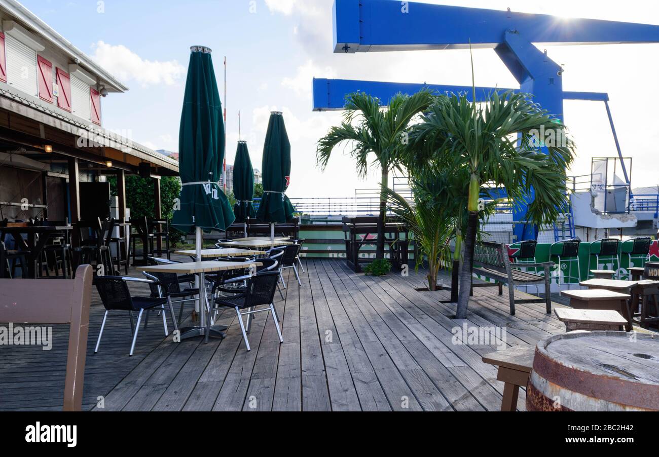 Normally busy this time of year, the deck at the Sint Maarten Yacht Club Bar & Restaurant is empty while closed for the Covid-19 Pandemic, March 2020 Stock Photo