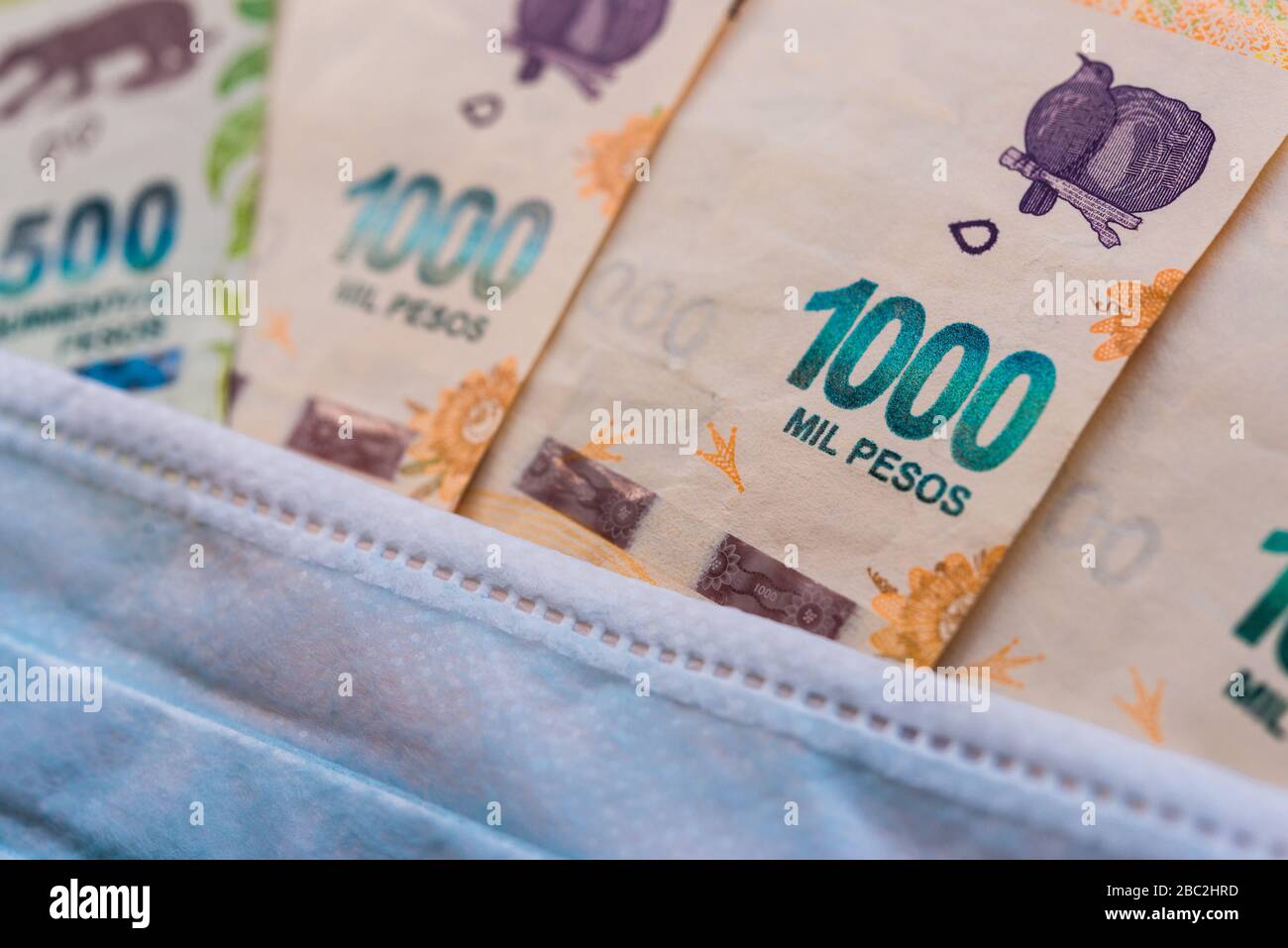 1000 and 500 Argentina peso with face mask against coronavirus covid-19 pandemic Stock Photo