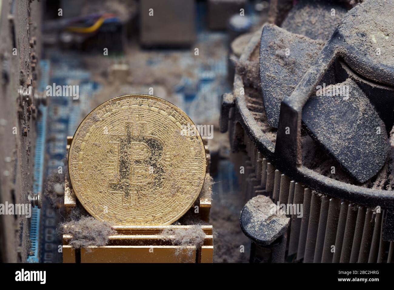 Dirty golden bitcoin inside an old broken computer covered with dust Stock  Photo - Alamy