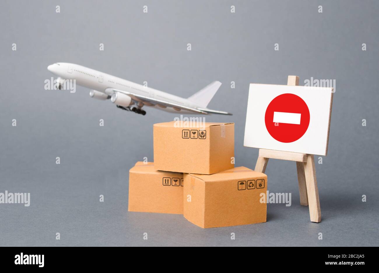 Cargo plane with boxes and an easel with a restriction sign. Restrictions on export of scarce and medical goods for the period of border closure quara Stock Photo