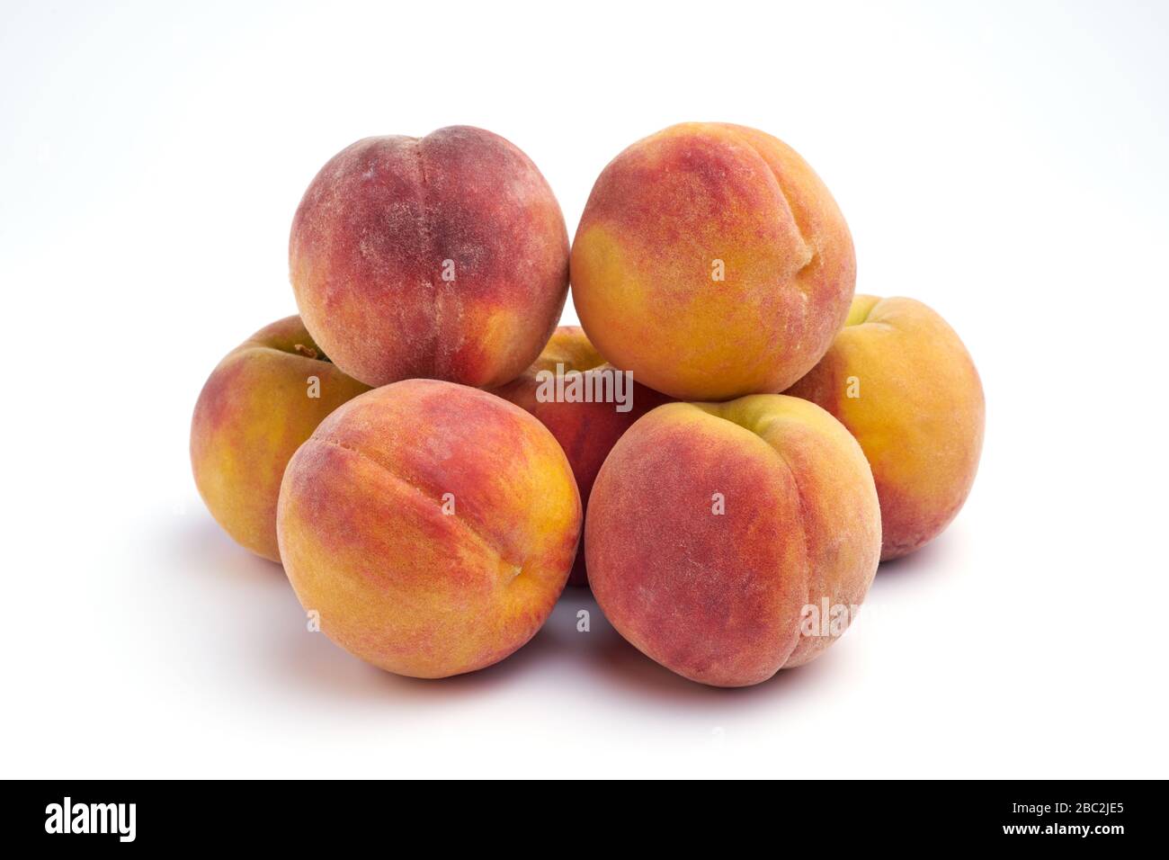 Several peaches isolated on white background. Stock Photo