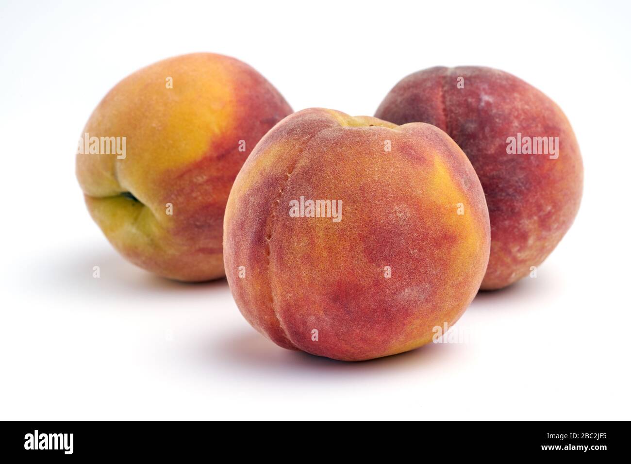 Several peaches isolated on white background. Stock Photo