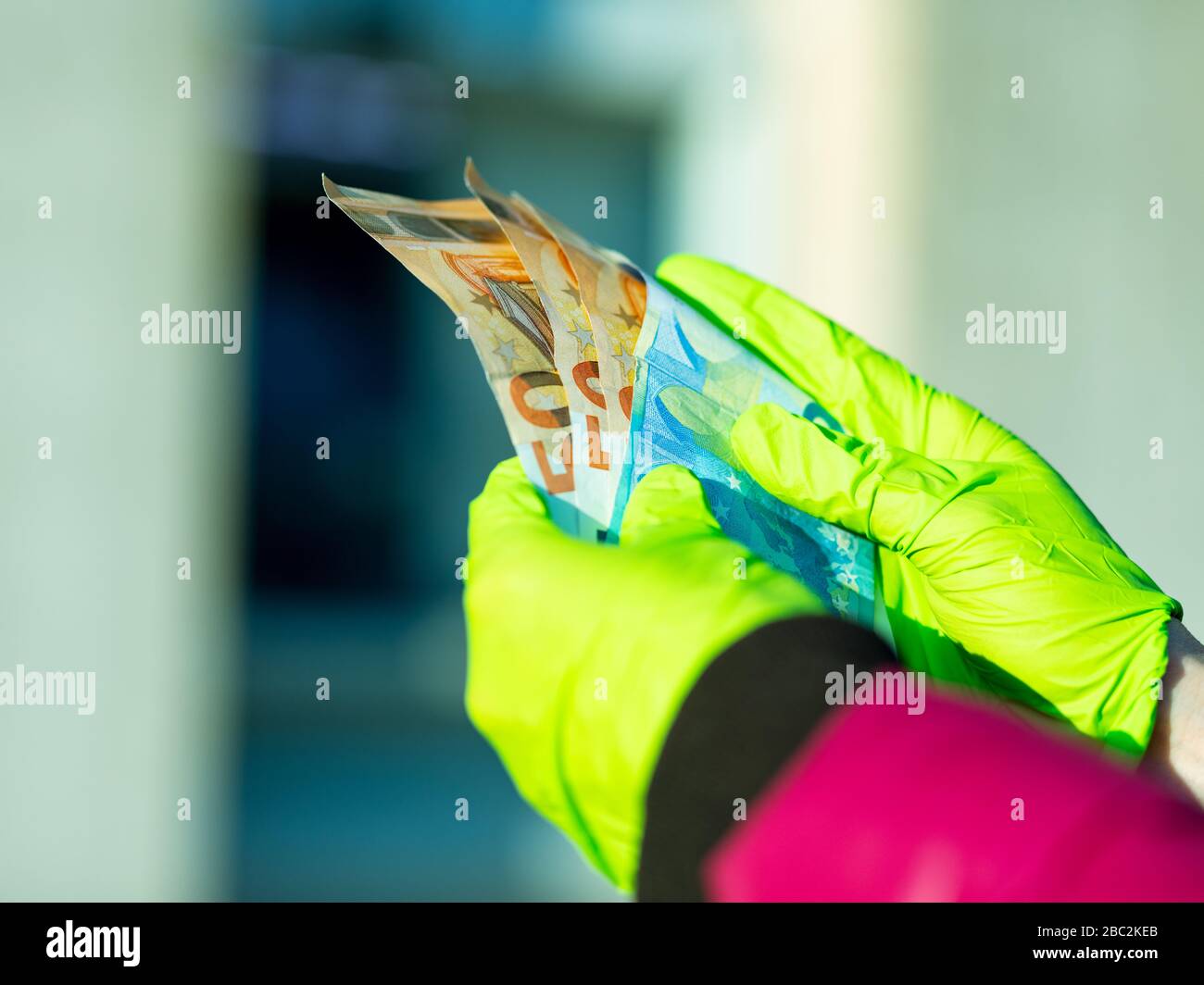 hands of a woman holding cash she struggled to withdraw from her local ATM in COVID19 corona virus pandemic times Stock Photo