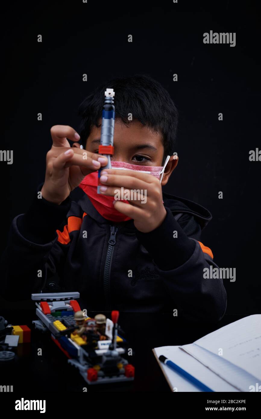 Asian Schoolboy playing and doing his study at home quarantine, Coronavirus Disease Stock Photo