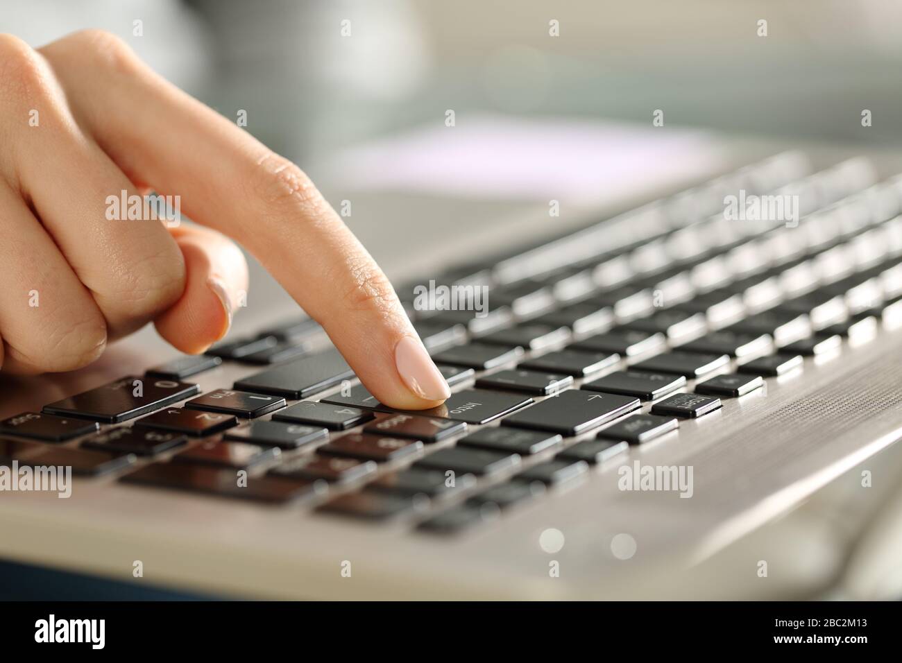 Close up of woman hands pressing enter button on a keyboard Stock Photo