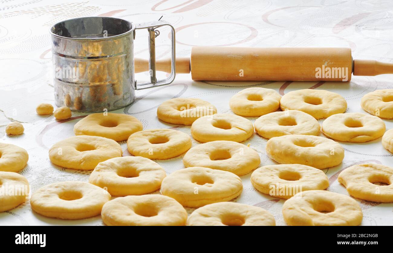 Donut dough is laid out on a table in the kitchen Stock Photo