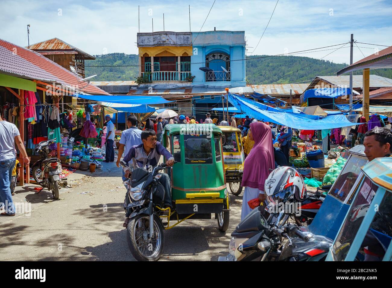 07 June 2018 Blangkejeren, Aceh, Sumatra, Indonesia: Old regular local motorcycle taxi called becak seen in busy crowded market in Kutapanjang village Stock Photo