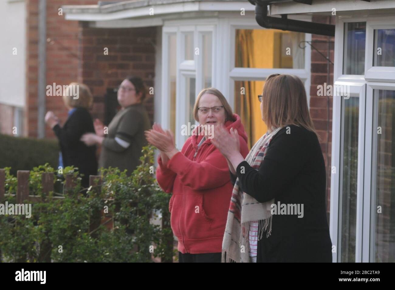 Kington, Herefordshire, UK. 2nd Apr, 2020. Residents in Llewellin Road in Kington take part in the Clap for Carers. The show of support was organised to thank key workers during the coronavirus pandemic. Credit: Andrew Compton/Alamy Live News Stock Photo