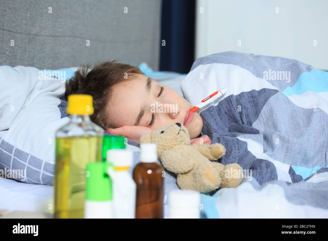 sick kid lying in bed with, Flue and fever , Sick child boy lying in
