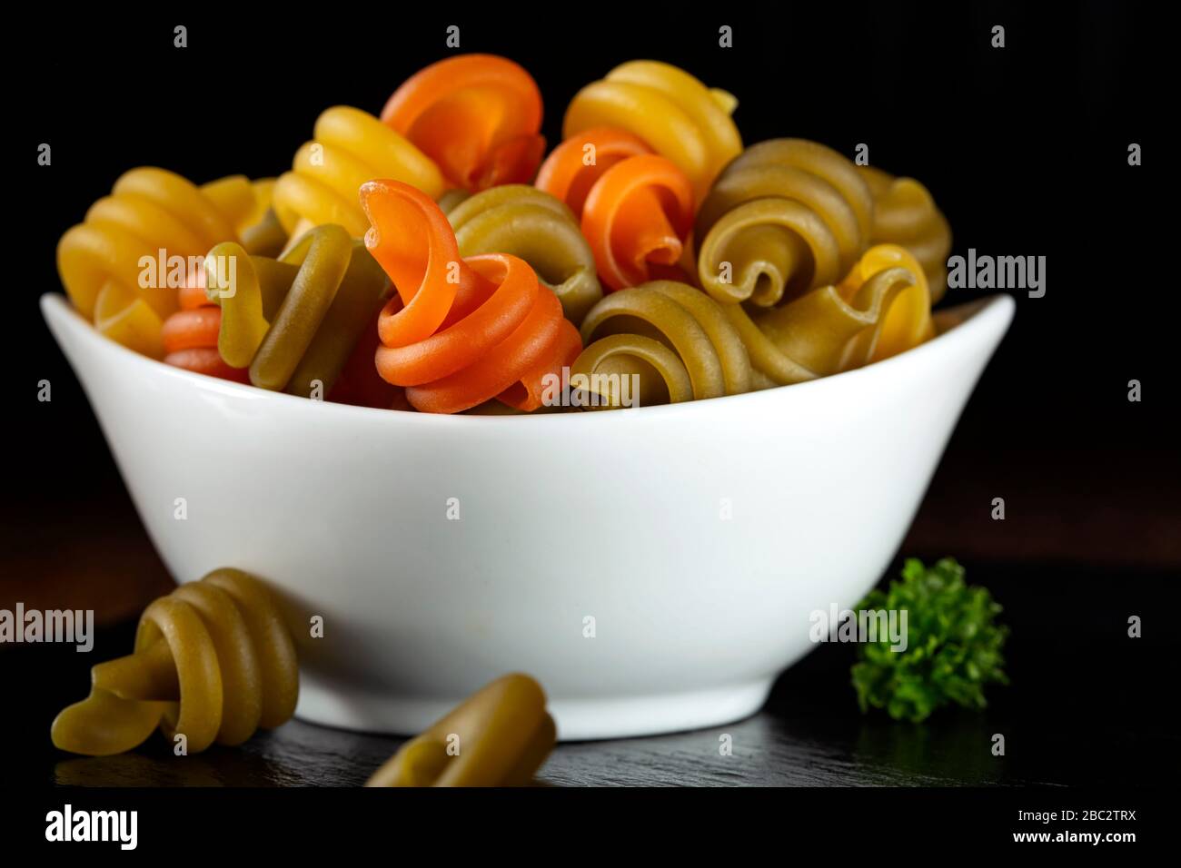 Uncooked trottole italian pasta in a white bowl Stock Photo