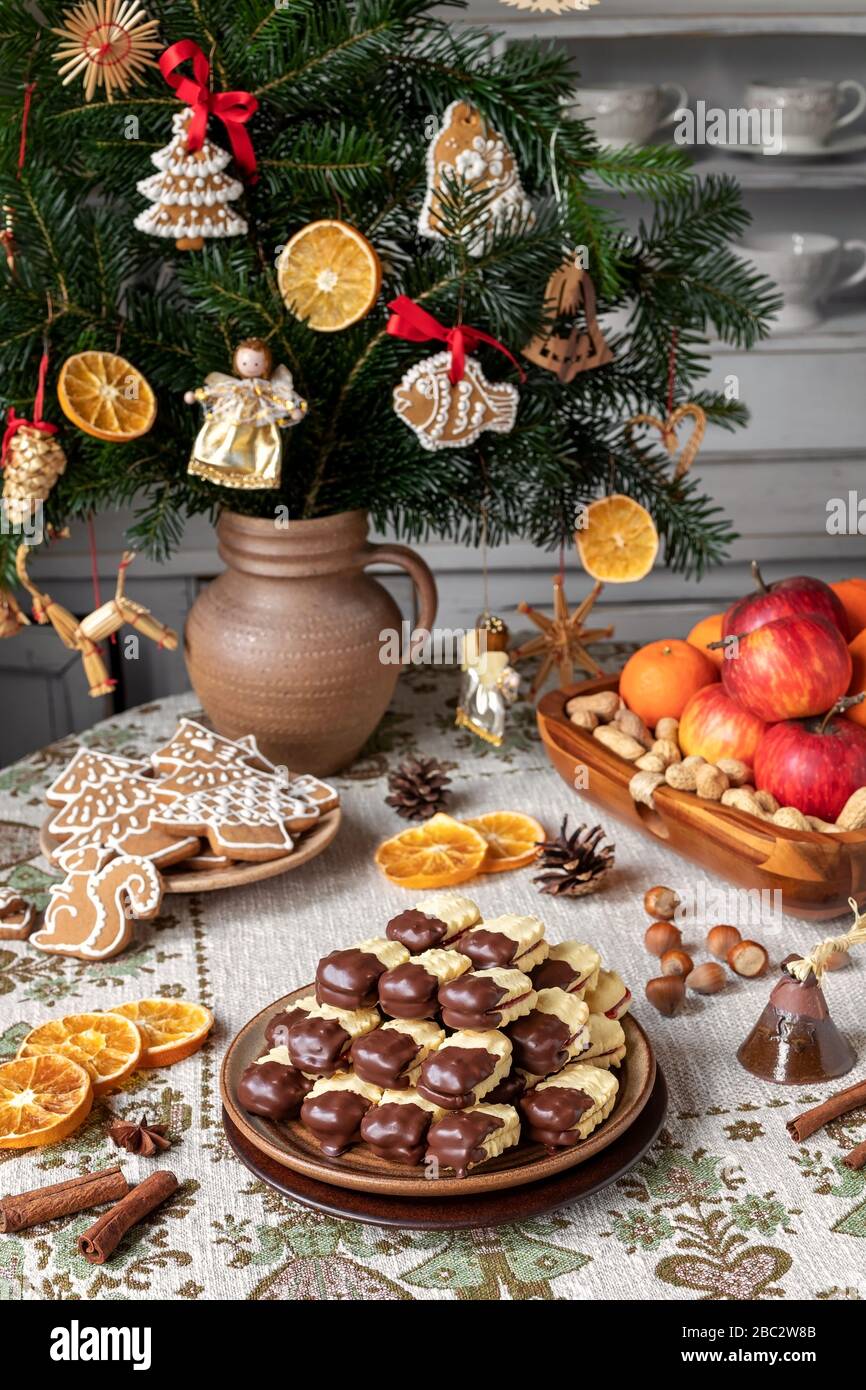 Christmas cookies filled with marmalade and dipped in chocolate, arranged on a plate Stock Photo