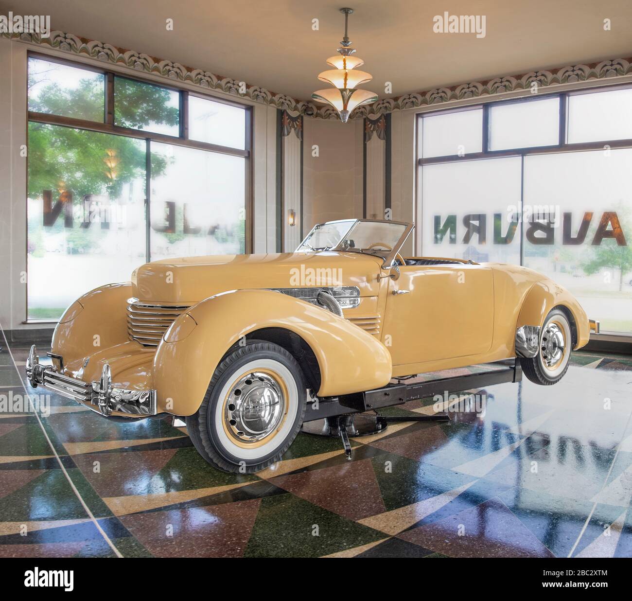 A1937 Cord supercharged 812 convertible on display in a 1930's  Deco showroom setting. Stock Photo