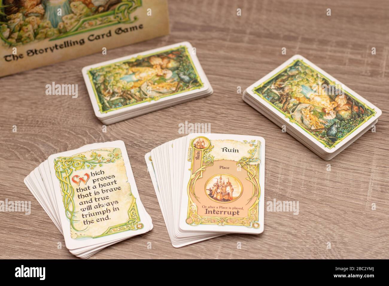 Once upon a time", storytelling card game for up to six players.Multiple  decks of cards on a wooden table. Word ruin in focus with ending cards  Stock Photo - Alamy