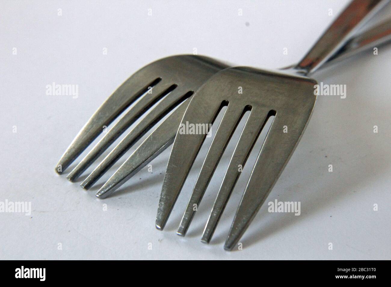 Close-up Of Forks On White Background Stock Photo