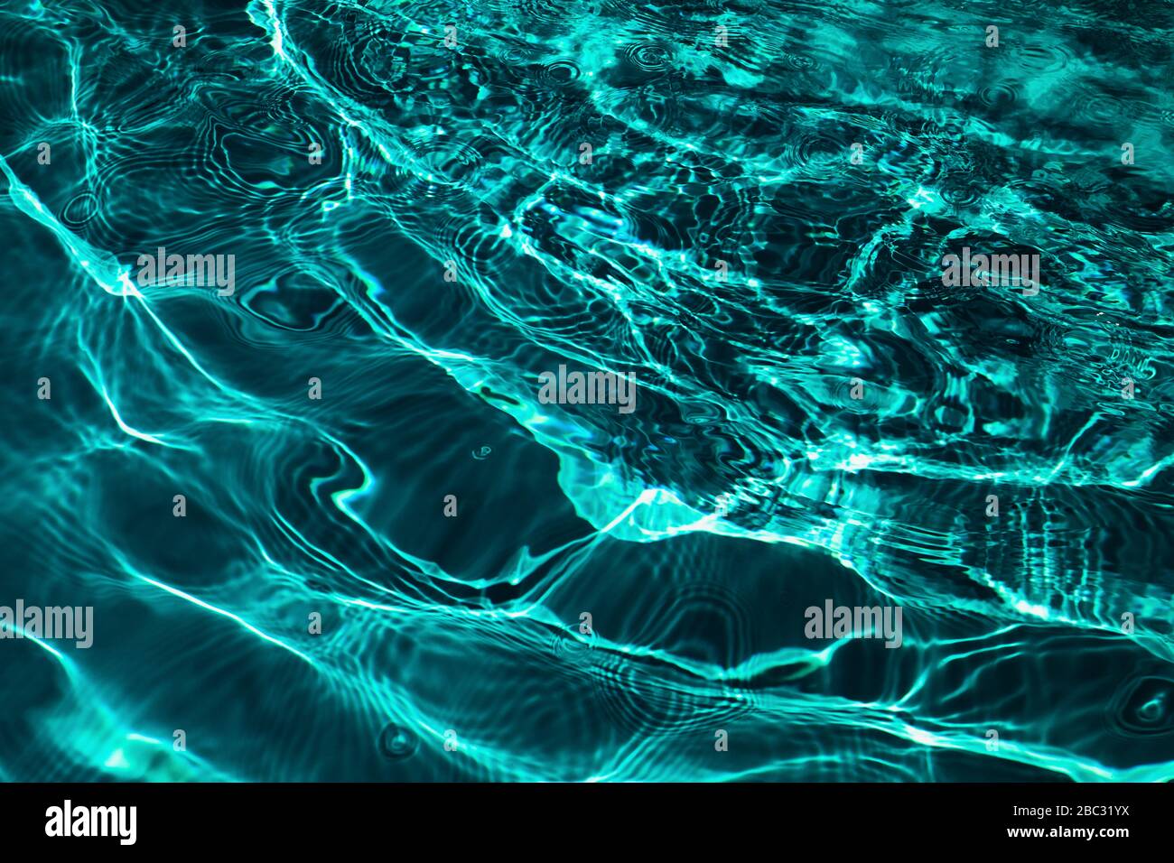 Closeup of rough water surface texture with splashes and bubbles in