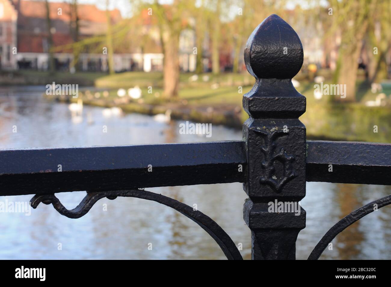 Black metal bridge fence with gothic letter b near beguinage in Bruges, Belgium, Europe Stock Photo