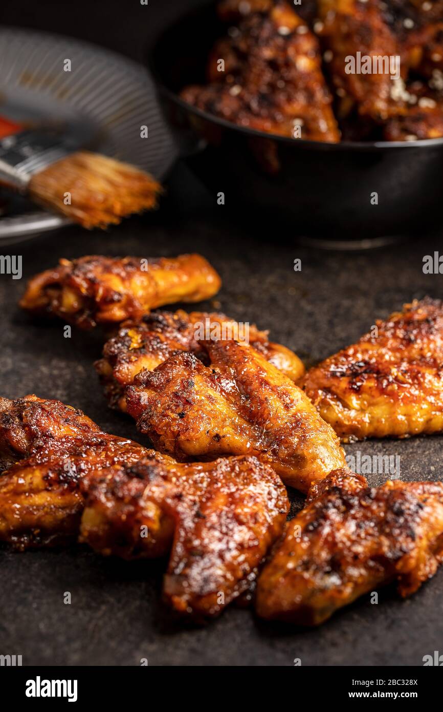 Grilled chicken wings on black rustical table. Stock Photo