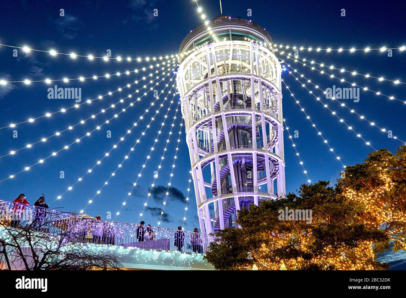 People enjoying Christmas lights near decorated tower Stock Photo Alamy