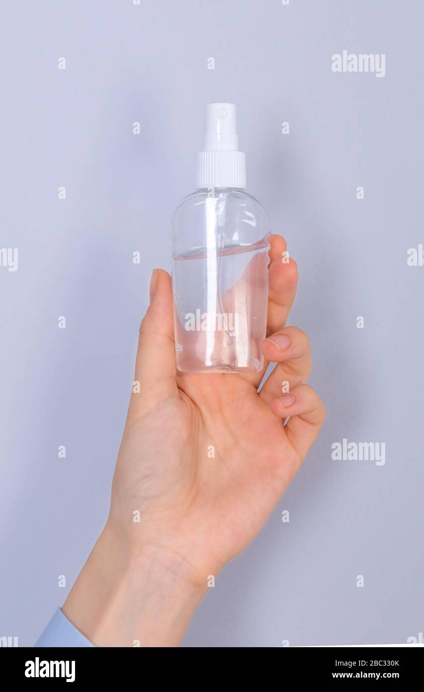 COVID-19 Pandemic Coronavirus. Close up woman hands using hands sanitizer alcohol gel dispenser, against 2019-nCoV. Antiseptic, Hygiene and Healthcare Stock Photo