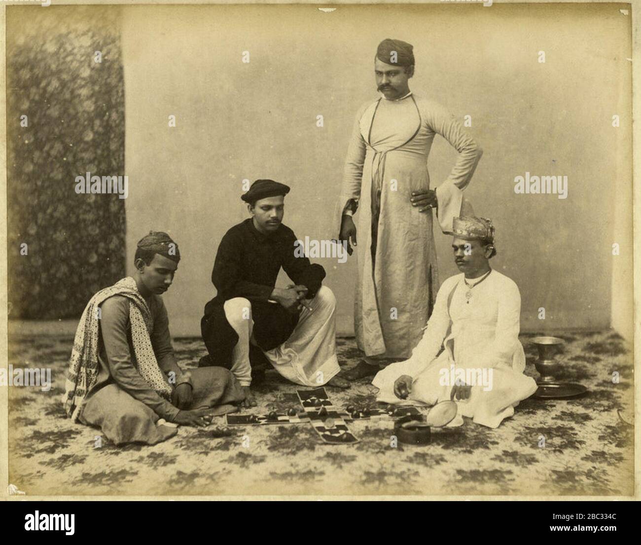 Group of Marwaree men playing chess actually pachisi a photo perhaps by Taurines, c.1880's. Stock Photo