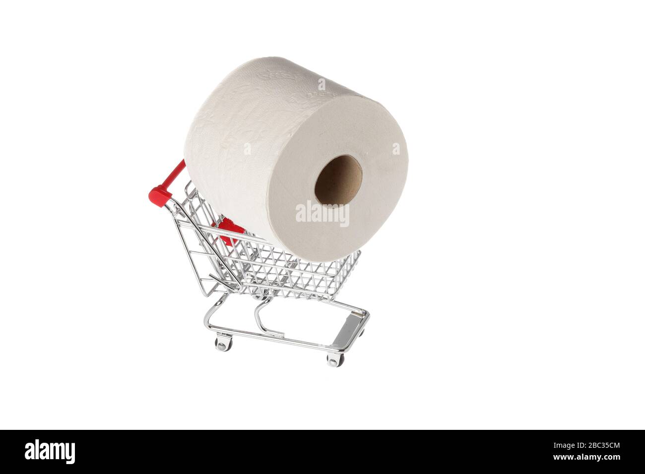 One roll of consumer toilet paper in miniature shopping cart isolated on white background. Stock Photo