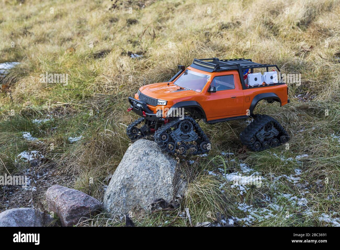 View of radio controlled model racing car on offroad background. Toys
