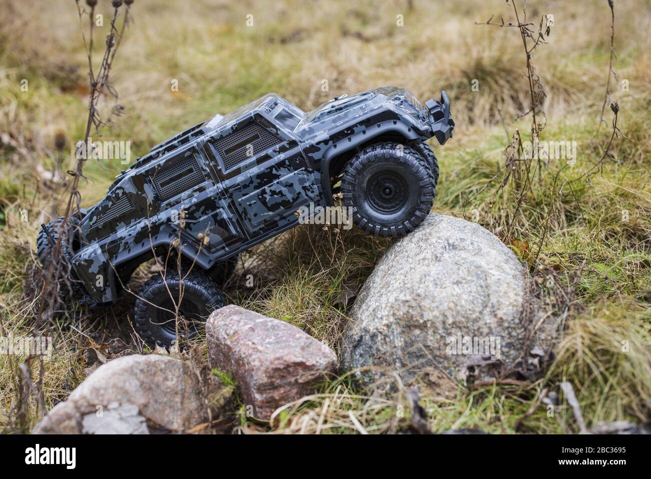View of radio controlled model racing car on offroad background. Toys