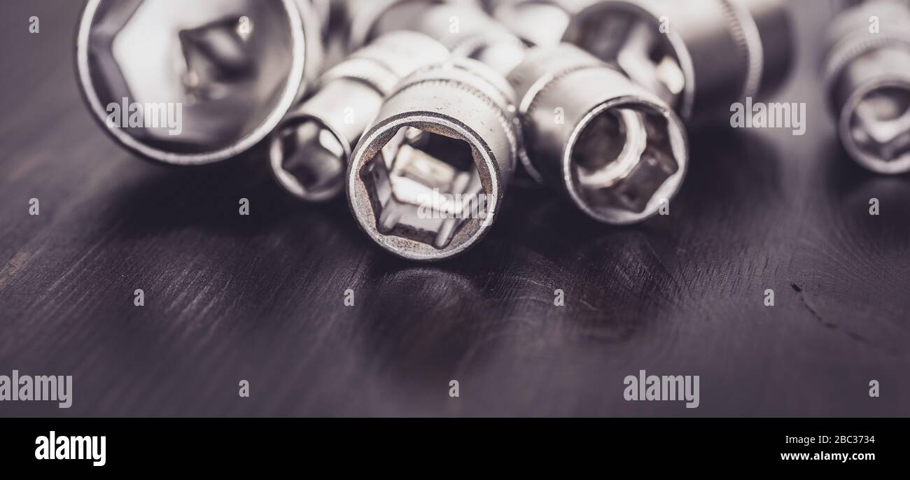 Socket wrenches isolated on wooden background Stock Photo