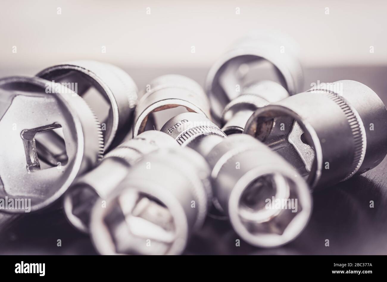 Socket wrenches isolated on wooden background Stock Photo