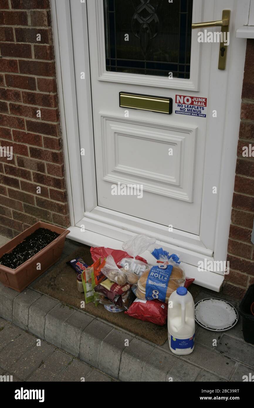 Essential food and grocery delivery left on step of elderly vulnerable household self-isolating during COVID-19 coronavirus pandemic Stock Photo