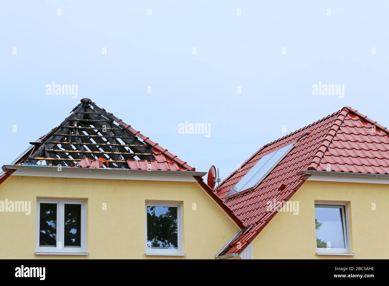 fire damage on rooftop of semi detached house Stock Photo