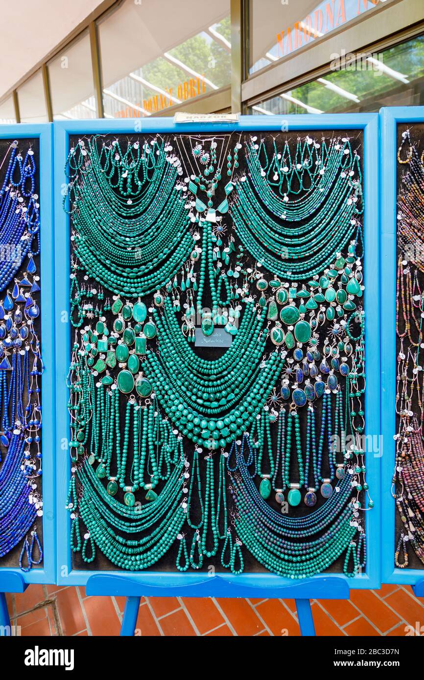 Display of colourful strings of green malachite beads and necklaces in a souvenir shop in Postojnska Jama (Postojna Cave Park), Slovenia Stock Photo