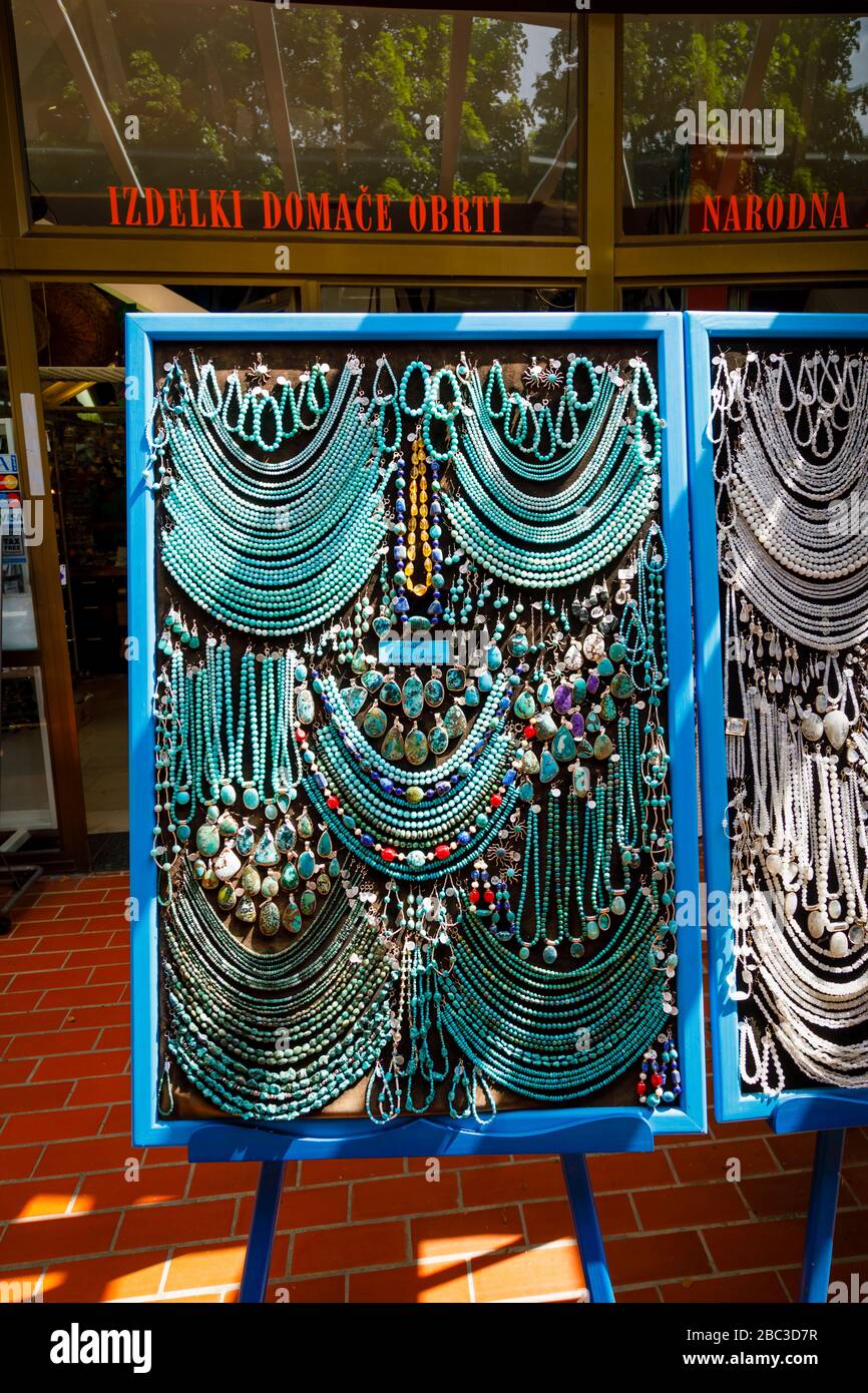 Display of colourful strings of turquoise stone beads and necklaces in a souvenir shop in Postojnska Jama (Postojna Cave Park), Slovenia Stock Photo