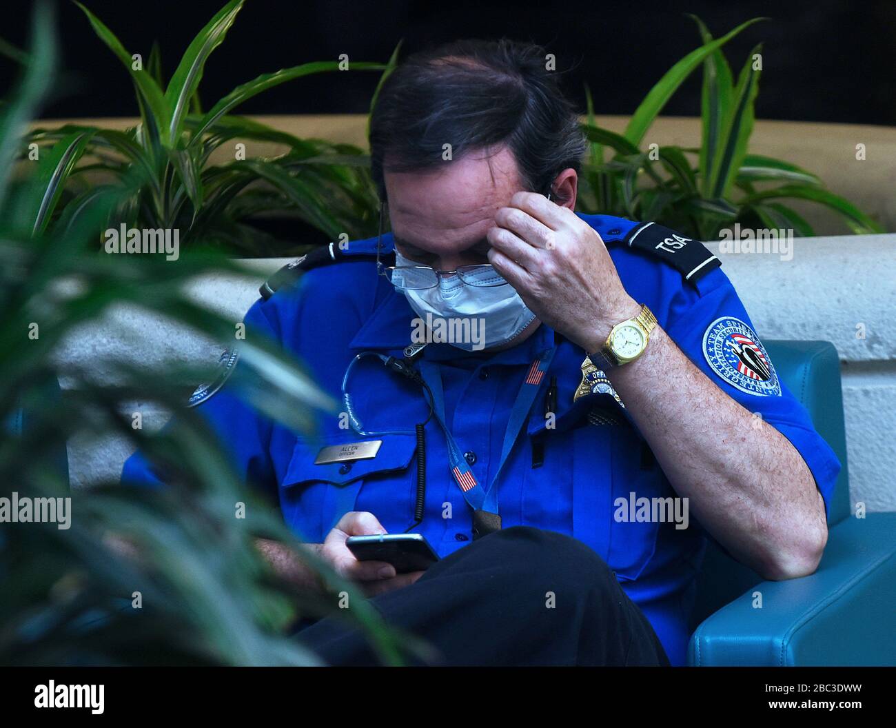 Orlando, United States. 02nd Apr, 2020. April 2, 2020 - Orlando, Florida, United States - A TSA officer wears a protective mask while taking a break on April 2, 2020 at Orlando International Airport in Orlando, Florida. In the past 14 days across the nation, 58 TSA screening officers have tested positive for COVID-19, including 9 in Orlando. Credit: Paul Hennessy/Alamy Live News Stock Photo