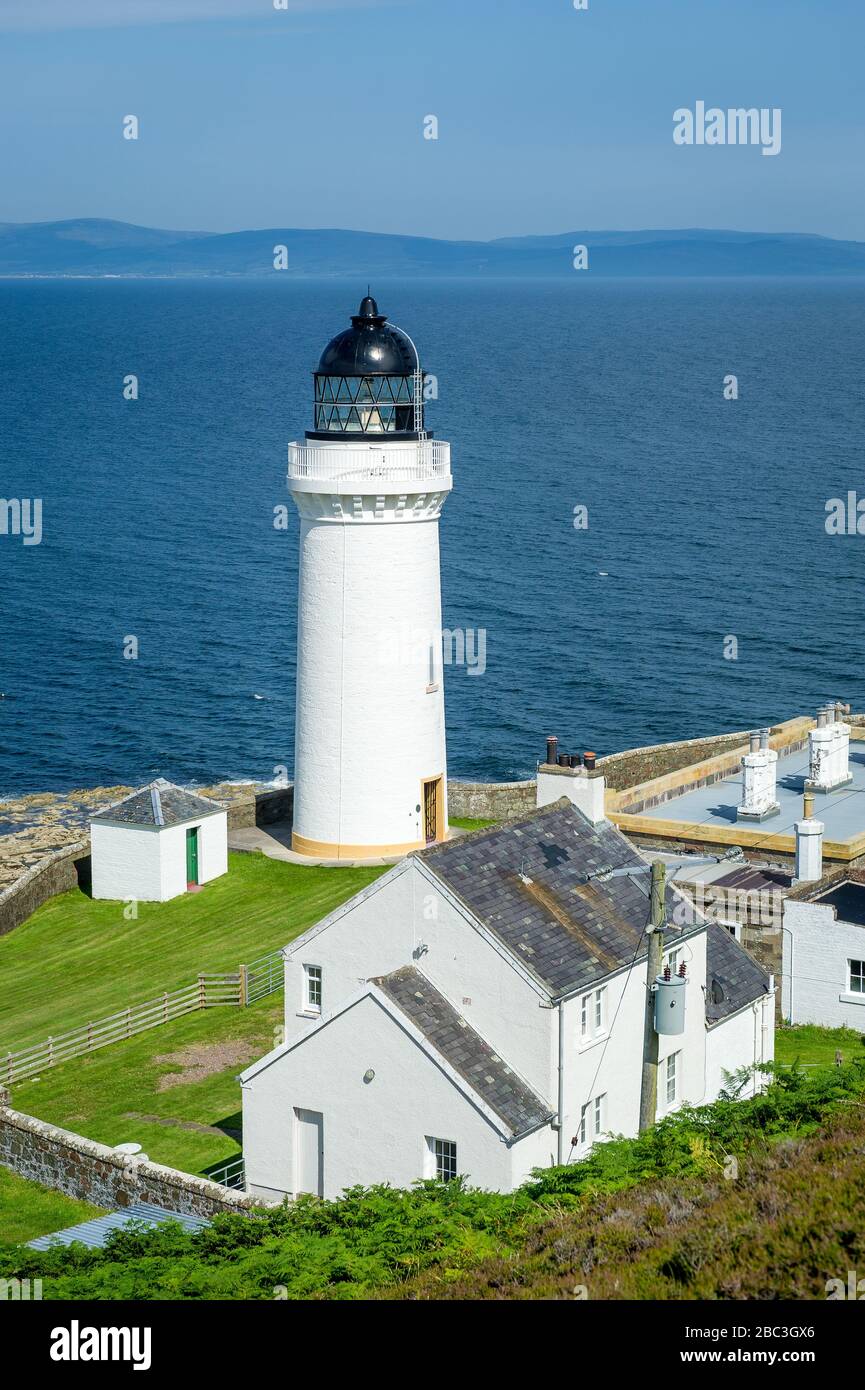 Davaar island white lighthouse and cottadges vertical photo. Campbeltown, Scotland Stock Photo