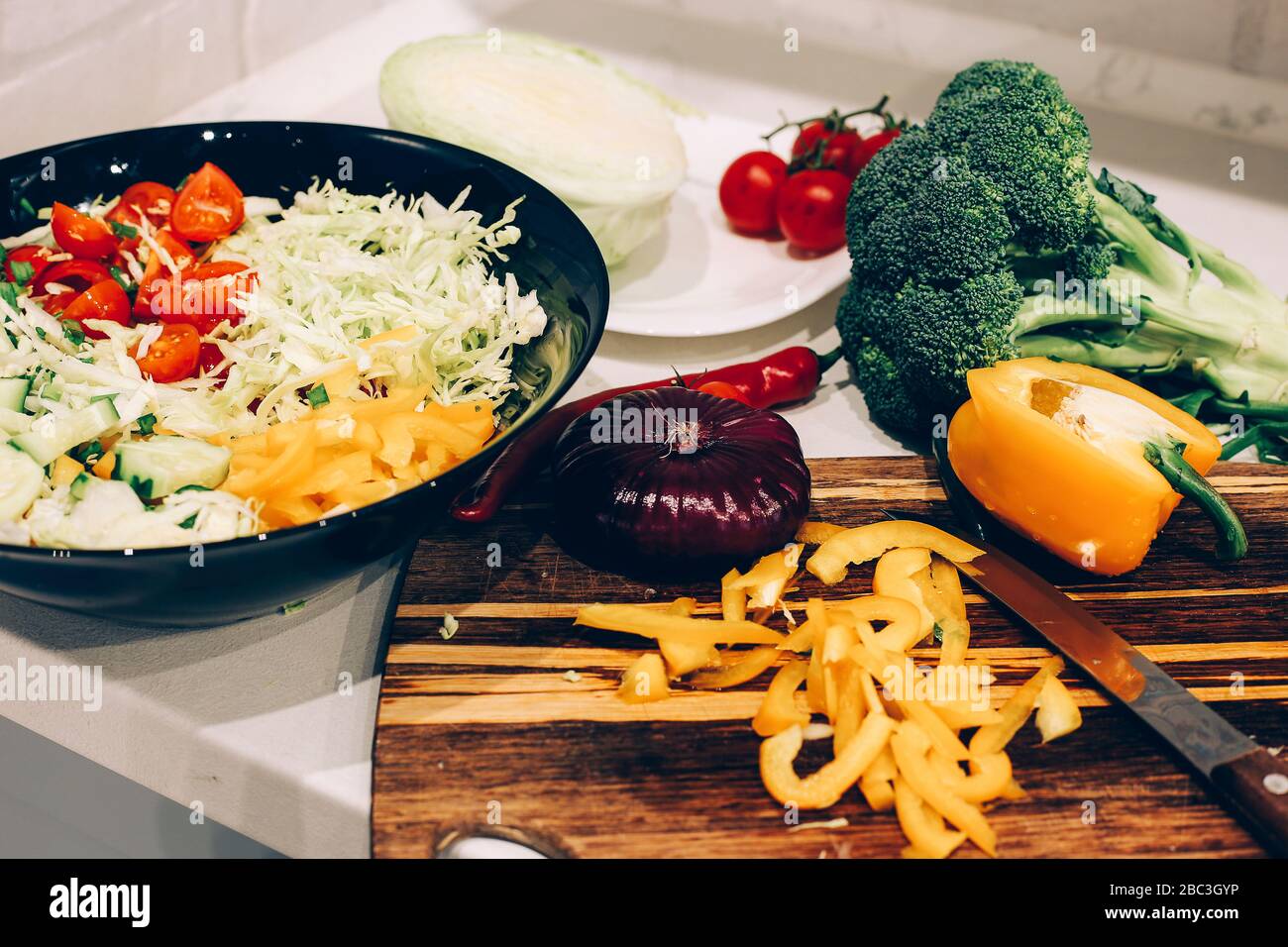 Making fresh salad on the kitchen. Ingredients for salad Stock Photo