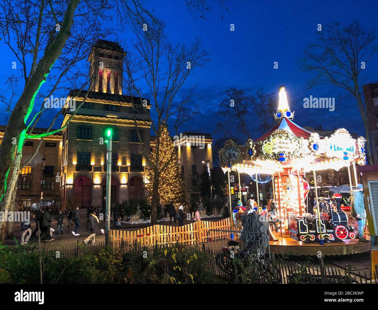 Montreuil, France, City Hall Building Lit up at Night with Merry-go-Round, Roundabout RIde on Town Square, suburban neighborhood Stock Photo