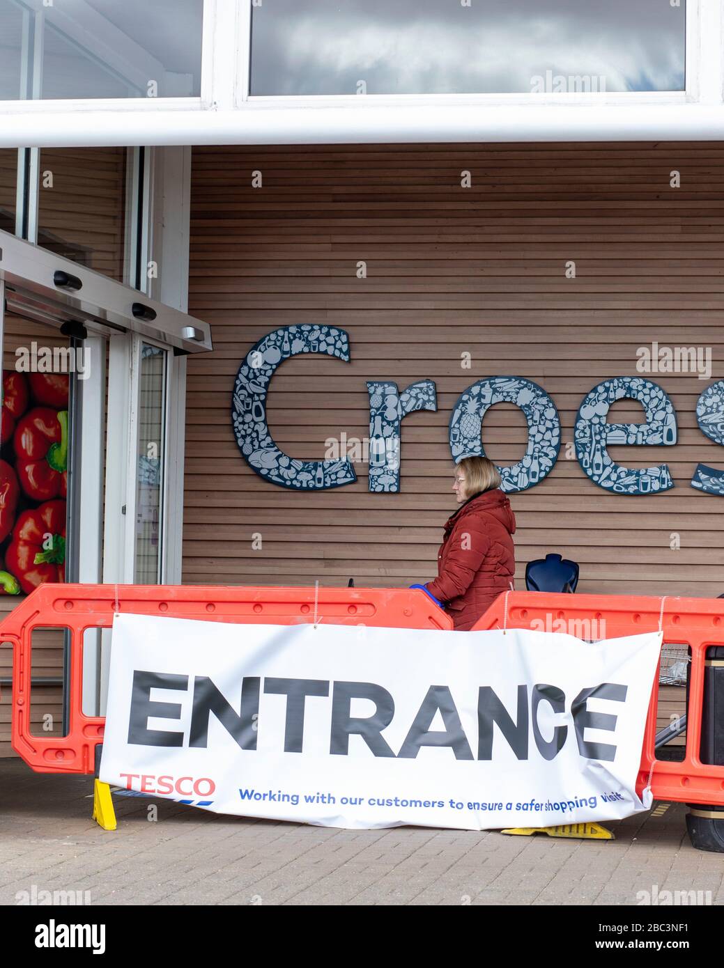 EBBW VALE, WALES, UK. MARCH 31 2020. Image of a woman queueing at the