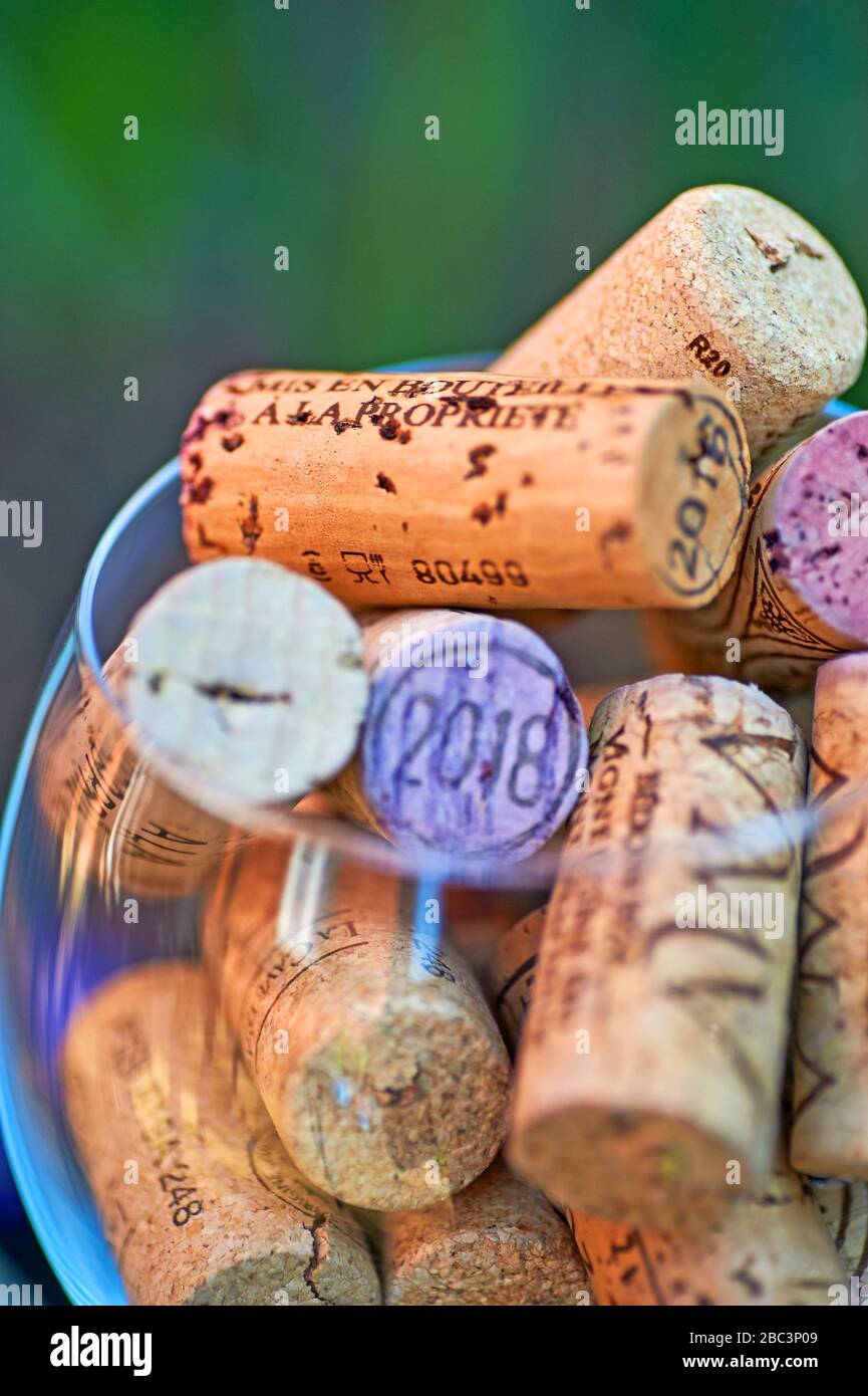 Abstract image of a wine glass full of wine bottles corks. Stock Photo