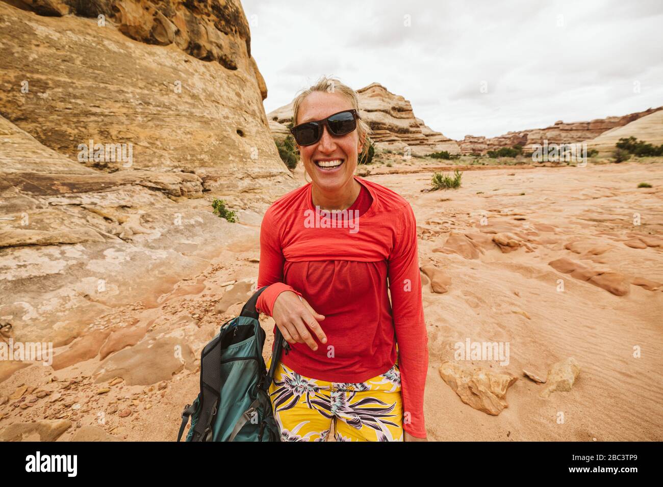 desert hiker with slanted sunglasses and messup up shirt laughing Stock Photo
