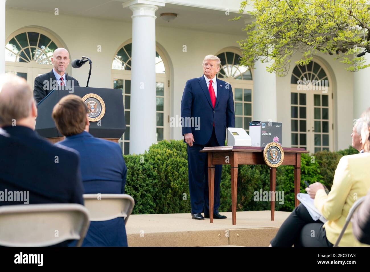 U.S President Donald Trump listens as Dr. Stephen Hahn, Commissioner of the Food and Drug Administration, delivers remarks at the daily COVID-19, coronavirus briefing in the Rose Garden of the White House March 30, 2020 in Washington, DC. Stock Photo