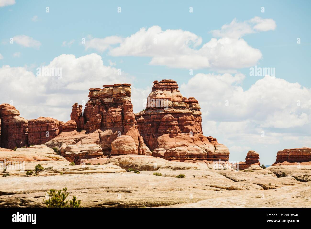 layered red sandstone towers on a sunny day in the maze utah Stock Photo