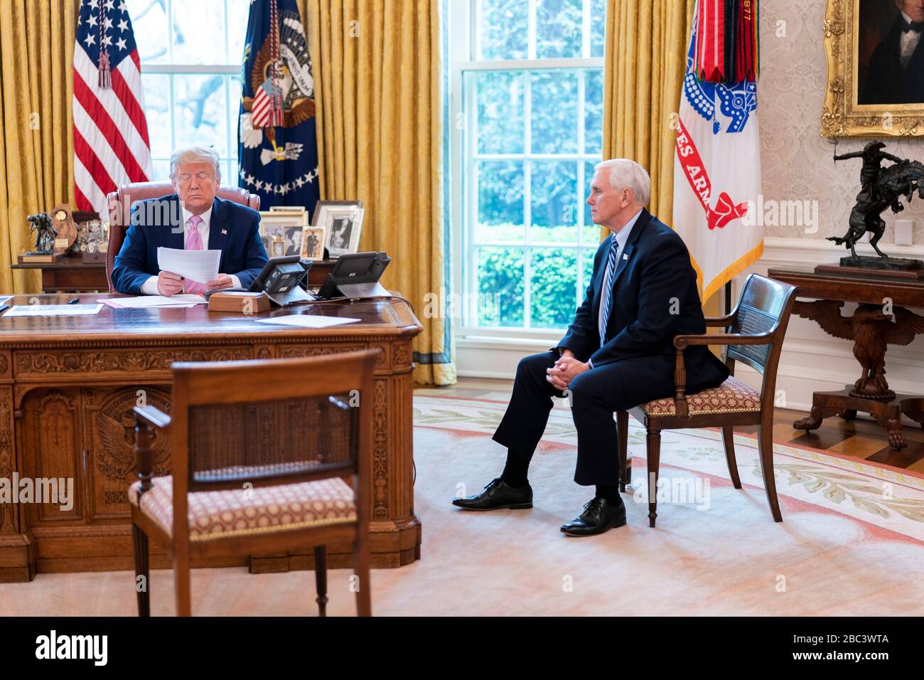 Washington, United States Of America. 01st Apr, 2020. Washington, United States of America. 01 April, 2020. U.S President Donald Trump and Vice President Mike Pence use the speaker phone to talk with military family members about the COVID-19, coronavirus pandemic from the Oval Office of the White House April 1, 2020 in Washington, DC. Credit: Tia Dufour/White House Photo/Alamy Live News Stock Photo
